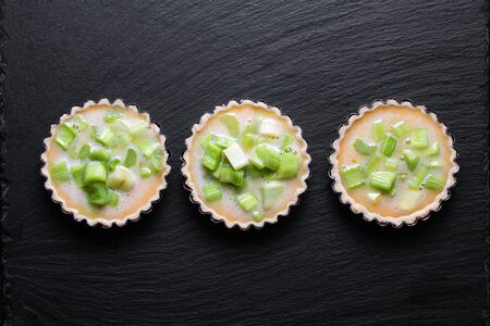 Home cooking concept top view Homemade organic Rhubarb pie on black slate stone boardの写真素材