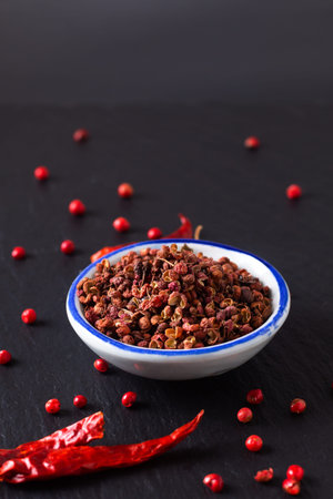 Food hot and spicy ingredients concept Sichuan, Szechuan, Szechwan pepper in small ceramic bowl on...