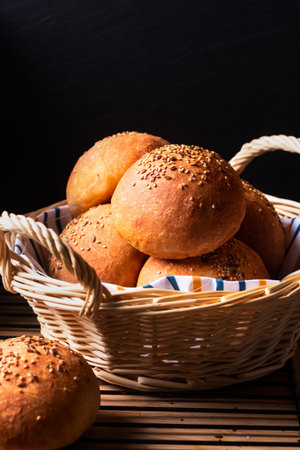 Food concept  fresh baked Homemade Hamburger buns on black background with copy space
