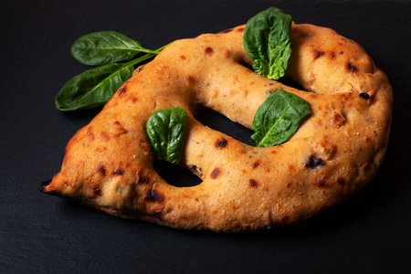 Food concept  traditoin French Fougasse artisan flatbread on black slate board with copy spaceの写真素材
