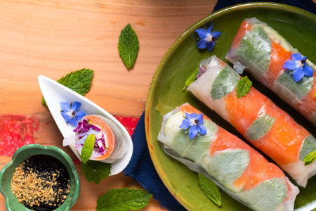 Healthy food concept Fresh smoked salmon rice paper spring rolls with colorful vegetable with copy spaceの写真素材