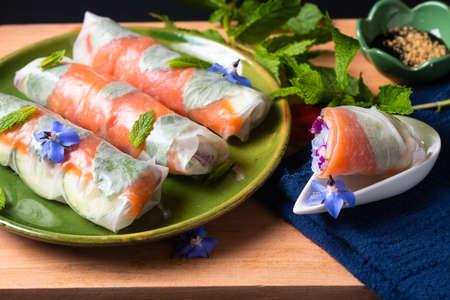 Healthy food concept Fresh smoked salmon rice paper spring rolls with colorful vegetable with copy spaceの写真素材