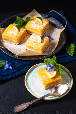 Food concept Homemade rustic Lemon bar pie on black background with copy spaceの写真素材