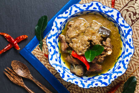 Food concept homemade Thai green curry in Thai classic ceramic Pedestal plate with copy spaceの写真素材