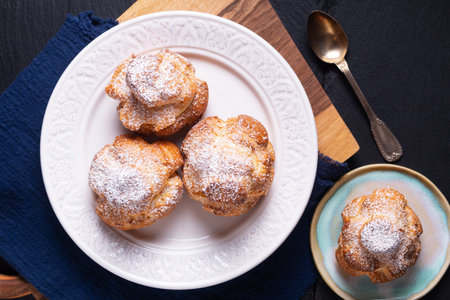 Food concept Homemade fresh baked Choux a la creme, Cream Puff, Choux Cream in white ceramic plate...