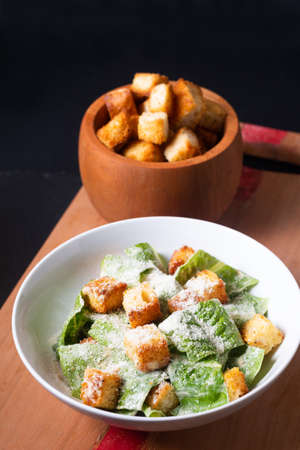 Food Concept Homemade organic classic Caesar Salad on wooden board with copy spaceの写真素材