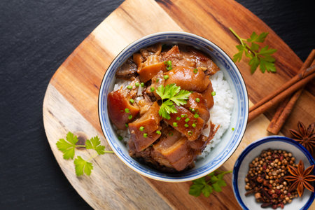 Food concept Spot focus Homemade Asian 5 spice  braised pork and rice on black background with copy spaceの写真素材