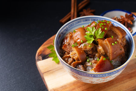 Food concept Spot focus Homemade Asian 5 spice  braised pork and rice on black background with copy spaceの写真素材