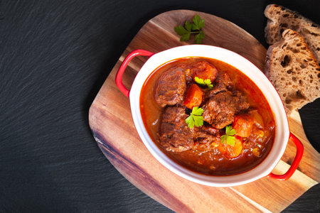 Food concept Homemade Beef stew Goulash on black background with copy spaceの写真素材