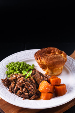 Food concept homemade Beer-Braised Shredded Beef with yorkshire pudding on black background with copy spaceの写真素材