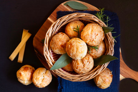 Food concept Spot focus French savory choux pastry gougÃ¨re, gougeres on black background with copy spaceの写真素材