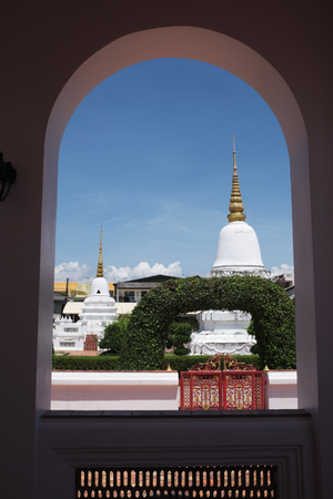 Pagodas in Thai temple see through round arch windowの写真素材