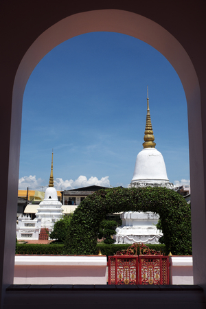 Pagodas in Thai temple see through round arch windowの写真素材