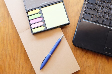 note book on wooden table の写真素材