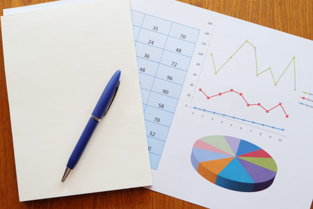 note book and chart on the wooden table