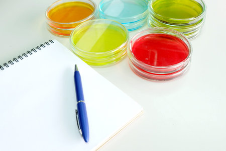 Colorful fluid in petridish for laboratory use on table in laboratory