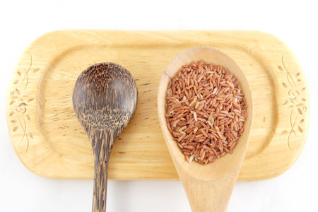 red rice in wooden spoonの写真素材