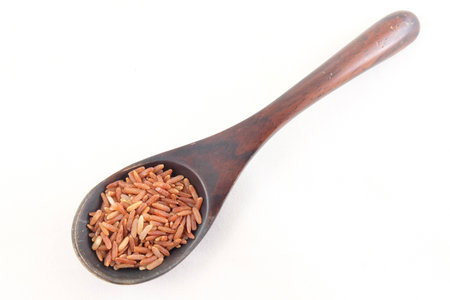 red rice in wooden spoon wareの写真素材