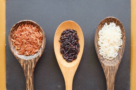 three type of rice in the spoon with blackboard backgroundの写真素材