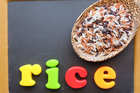 mix of rice in the spoon with blackboard backgroundの写真素材