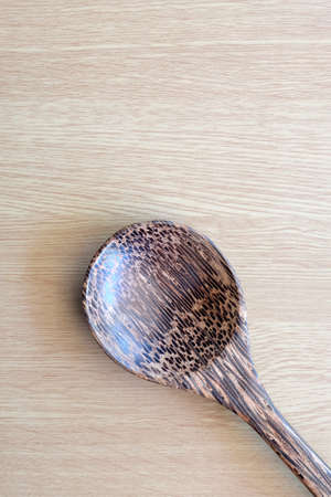wooden spoon on wooden backgroundの写真素材