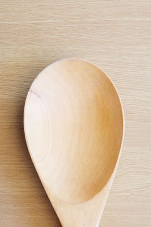 wooden spoon on wooden backgroundの写真素材