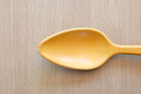 wooden spoon on wooden backgroundの写真素材