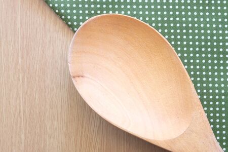 wooden spoon on wooden and dot cloth backgroundの写真素材