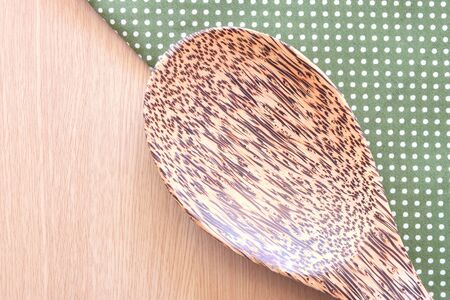 wooden spoon on wooden and dot cloth backgroundの写真素材