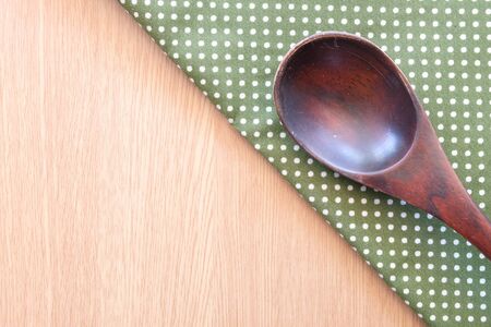 wooden spoon on wooden and dot cloth backgroundの写真素材