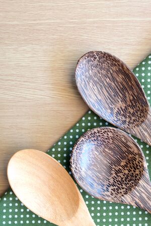 wooden spoon on wooden and dot cloth backgroundの写真素材