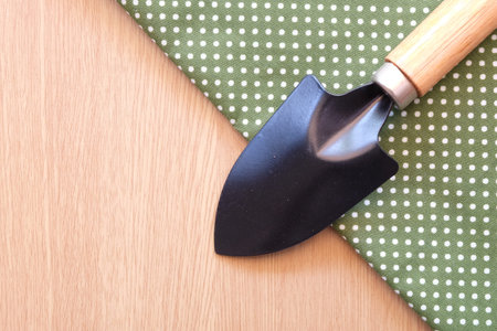 spade on wooden and dot cloth backgroundの写真素材