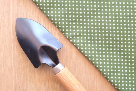 spade on wooden and dot cloth backgroundの写真素材