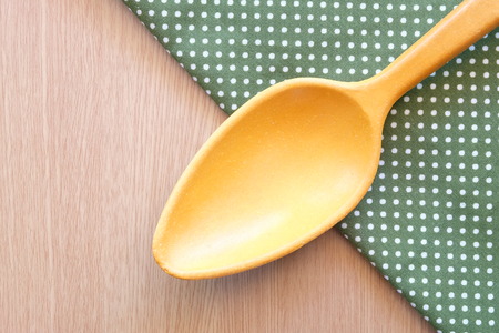 wooden spoon on wooden and dot cloth backgroundの写真素材