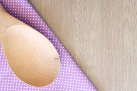 wooden spoon on wooden and dot cloth backgroundの写真素材