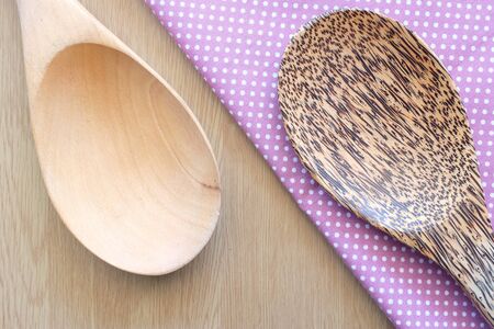 wooden spoon on wooden and dot cloth backgroundの写真素材