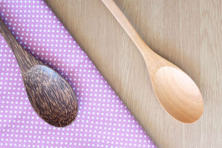 wooden spoon on wooden and dot cloth backgroundの写真素材