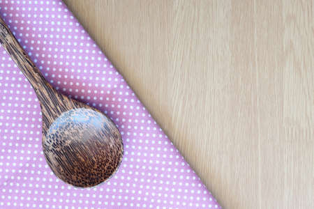 wooden spoon on wooden and dot cloth backgroundの写真素材