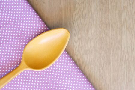 wooden spoon on wooden and dot cloth backgroundの写真素材