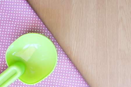 plastic spoon on wooden and dot cloth backgroundの写真素材