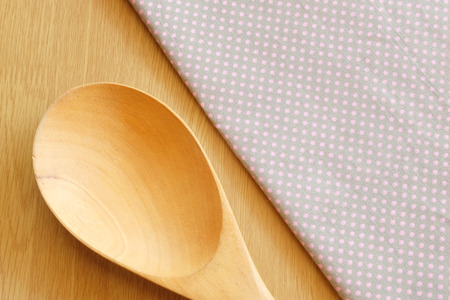 wooden spoon on wooden and dot cloth backgroundの写真素材
