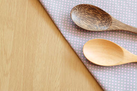 wooden spoon on wooden and dot cloth backgroundの写真素材