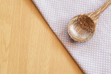wooden spoon on wooden and dot cloth backgroundの写真素材