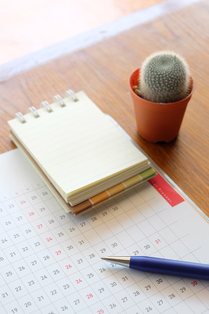 planner and note book on wooden tableの写真素材