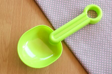 plastic spoon on wooden and dot cloth backgroundの写真素材