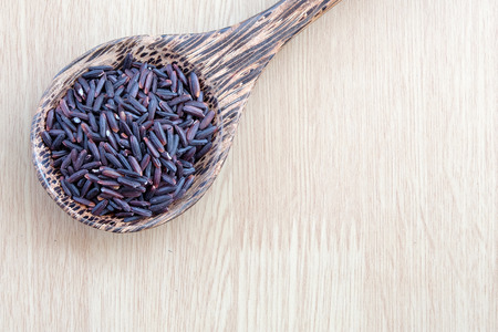 purple rice on wooden spoon with wooden backgroundの写真素材