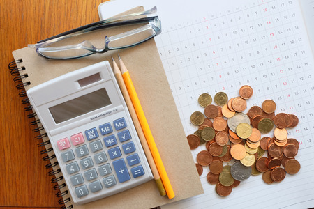 planner and money on wooden tableの写真素材