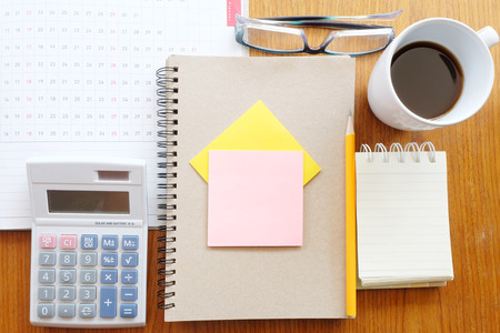 planner and calculator on wooden background with business conceptの写真素材