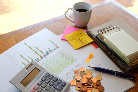 planner and chart on wooden background with business conceptの写真素材