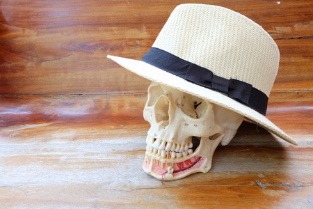 skull and hat on wooden backgroundの写真素材